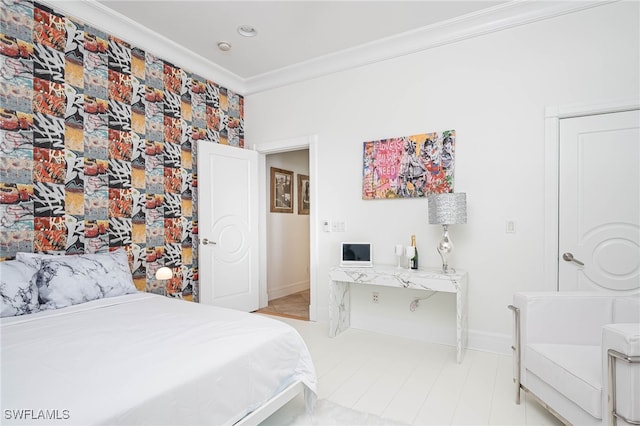 bedroom with ornamental molding and baseboards
