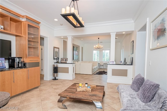 living area featuring crown molding, light tile patterned floors, ornate columns, and a chandelier