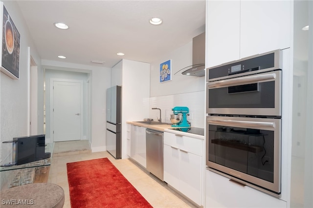 kitchen featuring white cabinets, appliances with stainless steel finishes, modern cabinets, and a sink