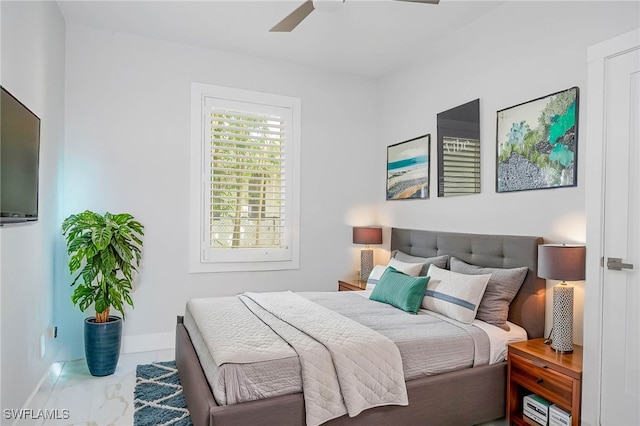 bedroom with baseboards, a ceiling fan, and marble finish floor