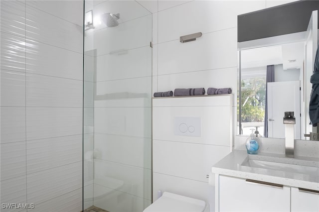 full bathroom featuring vanity, toilet, and a tile shower