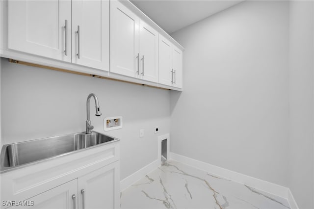 2932 18th St SW, Lehigh Acres, FL 33976 - washroom featuring cabinet space, electric dryer hookup, washer hookup, marble look tile flooring, and baseboards