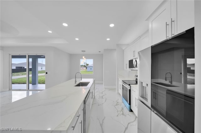 2932 18th St SW, Lehigh Acres, FL 33976 - kitchen featuring stainless steel appliances, a sink, recessed lighting, light marble finish floors, and healthy amount of natural light