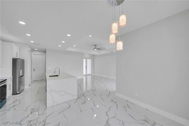 2932 18th St SW, Lehigh Acres, FL 33976 - kitchen with freestanding refrigerator, recessed lighting, a ceiling fan, light marble finish flooring, and baseboards