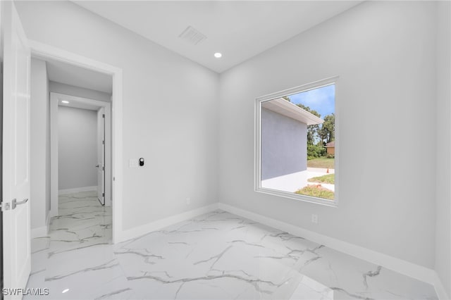 2932 18th St SW, Lehigh Acres, FL 33976 - unfurnished room featuring marble look tile flooring, baseboards, and recessed lighting