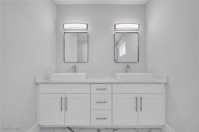 2932 18th St SW, Lehigh Acres, FL 33976 - bathroom featuring marble look tiles, baseboards, and double vanity