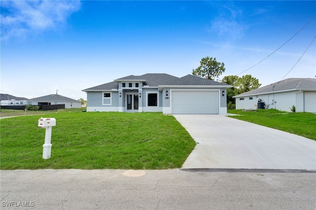 2932 18th St SW, Lehigh Acres, FL 33976 - prairie-style home featuring stucco siding, a garage, concrete driveway, and a front lawn