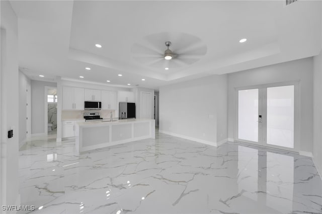 2932 18th St SW, Lehigh Acres, FL 33976 - unfurnished living room with a raised ceiling, recessed lighting, french doors, baseboards, and a ceiling fan