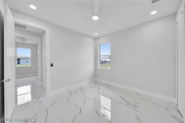 2932 18th St SW, Lehigh Acres, FL 33976 - spare room featuring ceiling fan, marble tiled flooring, healthy amount of natural light, baseboards, and recessed lighting