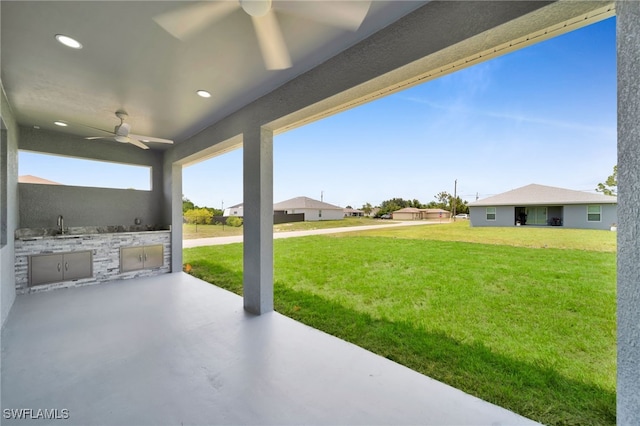 2932 18th St SW, Lehigh Acres, FL 33976 - view of patio / terrace with an outdoor kitchen, ceiling fan, and a sink