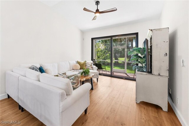 living area with ceiling fan, light wood-type flooring, and baseboards
