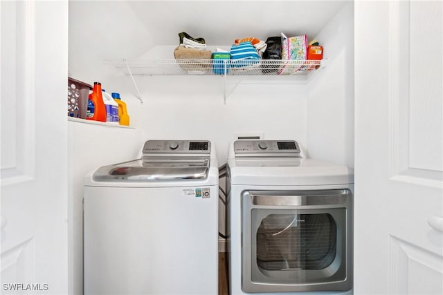clothes washing area featuring washing machine and dryer and laundry area