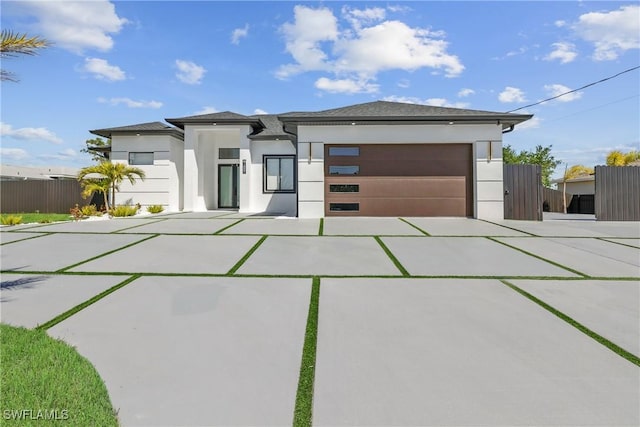 1007 NW 19th St, Cape Coral, FL 33993 - prairie-style house with an attached garage, driveway, stucco siding, and fence
