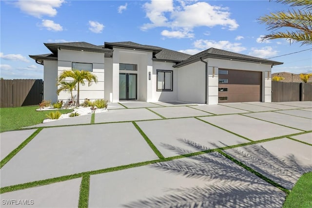 1007 NW 19th St, Cape Coral, FL 33993 - view of front of property with stucco siding, fence, a garage, and concrete driveway