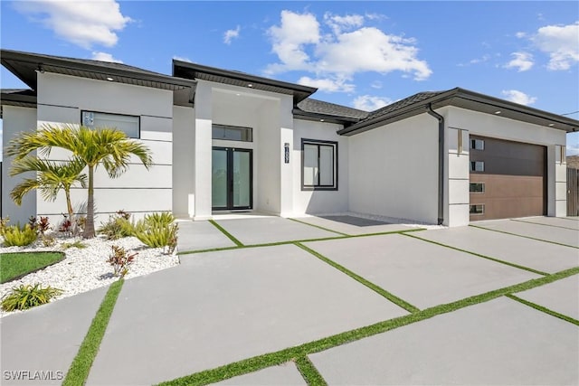 1007 NW 19th St, Cape Coral, FL 33993 - view of front facade featuring stucco siding, a garage, and concrete driveway