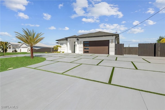 1007 NW 19th St, Cape Coral, FL 33993 - view of front of home with stucco siding, an attached garage, fence, and driveway