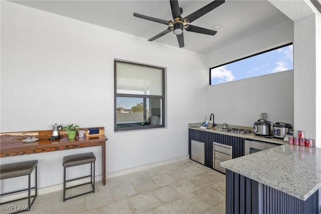 1007 NW 19th St, Cape Coral, FL 33993 - kitchen with ceiling fan and light stone countertops