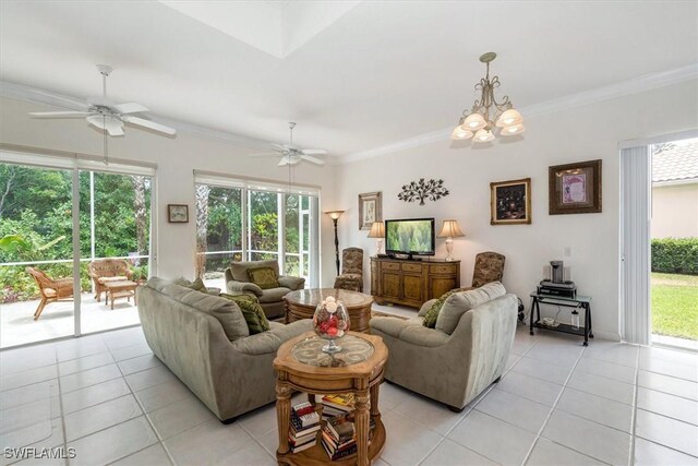 living room featuring light tile patterned floors, ceiling fan with notable chandelier, and crown molding