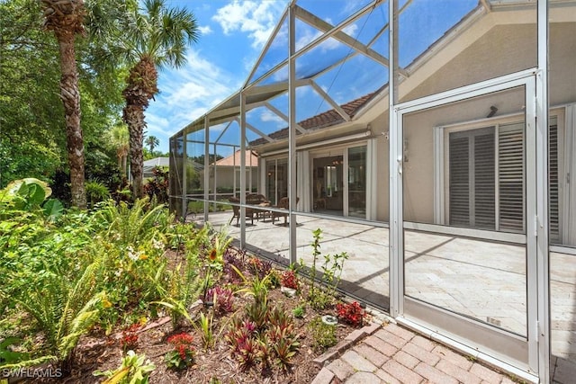 back of house with a patio area and glass enclosure