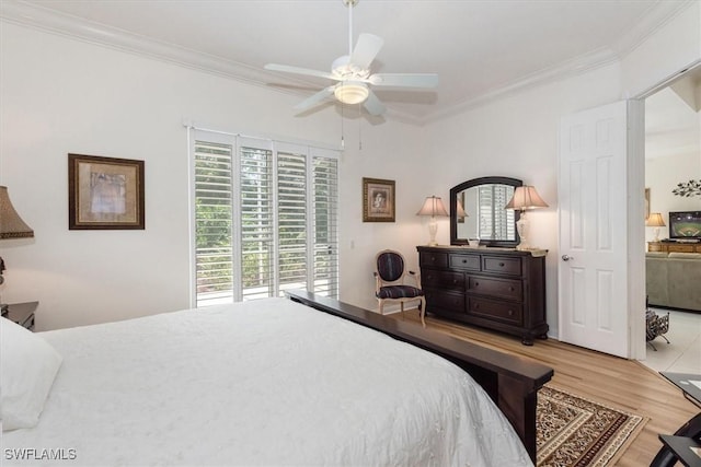 bedroom featuring crown molding, multiple windows, access to outside, and light wood-style flooring