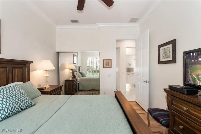 bedroom with visible vents, ornamental molding, and a closet