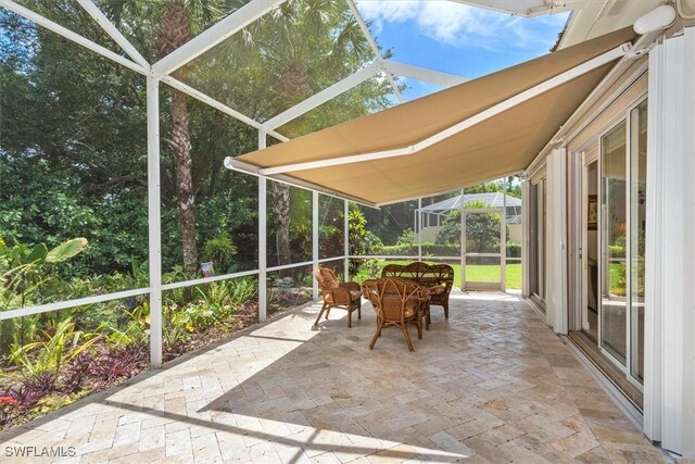 sunroom featuring outdoor dining space