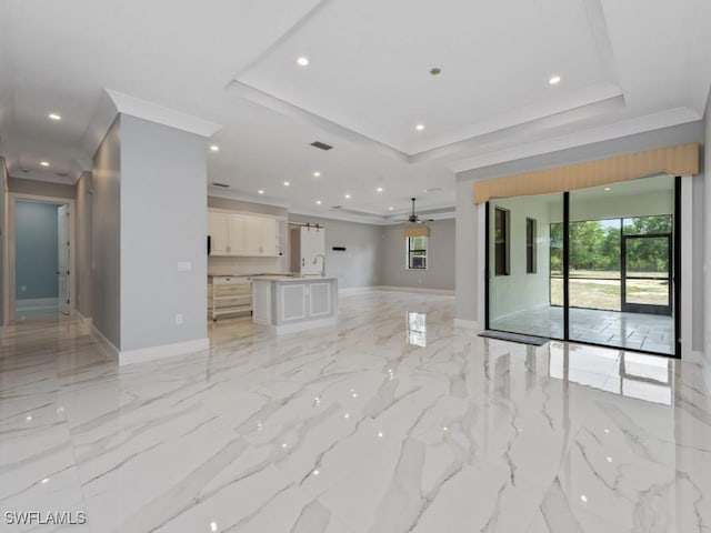 2538 4th Ave NE, Naples, FL 34120 - unfurnished living room with recessed lighting, marble finish floor, ornamental molding, baseboards, and a tray ceiling
