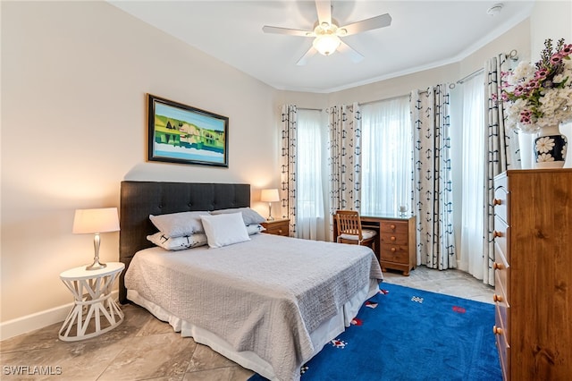 bedroom featuring baseboards and ceiling fan