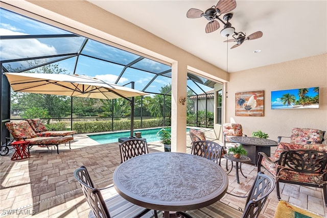 view of patio with outdoor lounge area, a ceiling fan, a lanai, and an outdoor pool