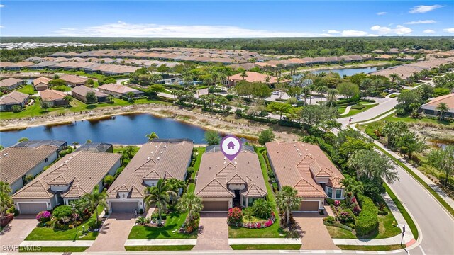 drone / aerial view featuring a residential view and a water view