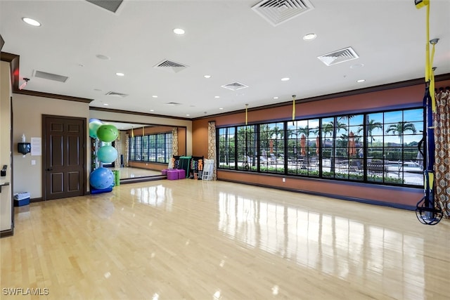 exercise area with visible vents, recessed lighting, and crown molding