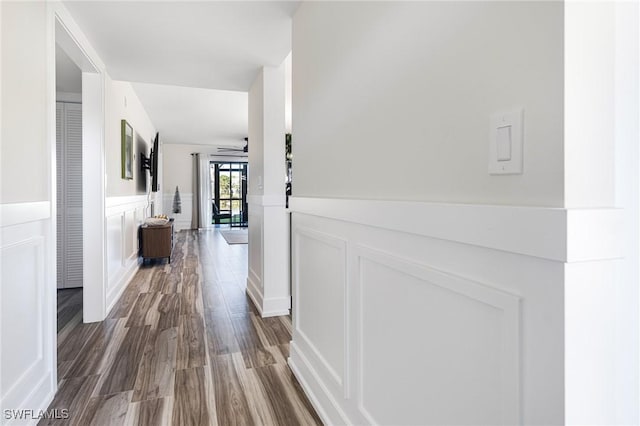 12181 Kelly Sands Way Unit 1538, Fort Myers, FL 33908 - hallway featuring dark wood finished floors, a decorative wall, and a wainscoted wall
