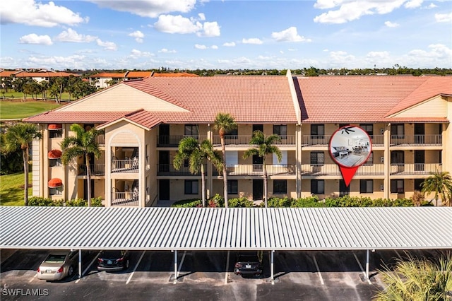 12181 Kelly Sands Way Unit 1538, Fort Myers, FL 33908 - view of building exterior featuring covered and uncovered parking
