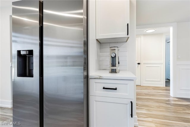 12181 Kelly Sands Way Unit 1538, Fort Myers, FL 33908 - kitchen featuring stainless steel fridge with ice dispenser, light countertops, light wood-style flooring, and white cabinets