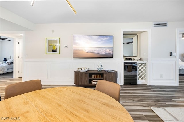 12181 Kelly Sands Way Unit 1538, Fort Myers, FL 33908 - dining space with visible vents, a decorative wall, ceiling fan, and wine cooler