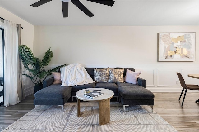 12181 Kelly Sands Way Unit 1538, Fort Myers, FL 33908 - living room featuring wainscoting, ceiling fan, a decorative wall, and light wood-type flooring