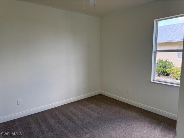 4328 NW 27th Ter, Cape Coral, FL 33993 - spare room with dark carpet and baseboards
