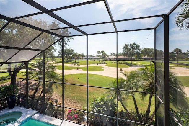 view of pool with golf course view, glass enclosure, and a pool with connected hot tub