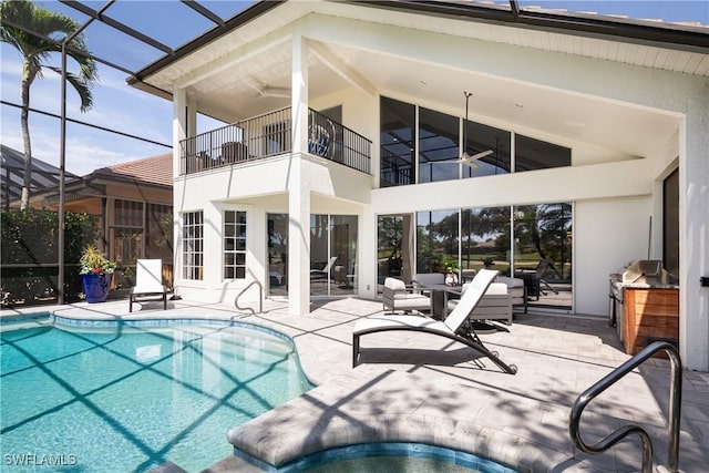 pool with a patio, ceiling fan, and a lanai
