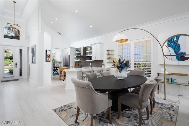 dining area featuring a chandelier, recessed lighting, ornamental molding, and baseboards