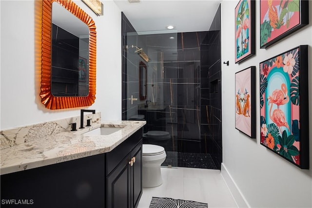 bathroom featuring recessed lighting, vanity, toilet, a tile shower, and tile patterned flooring