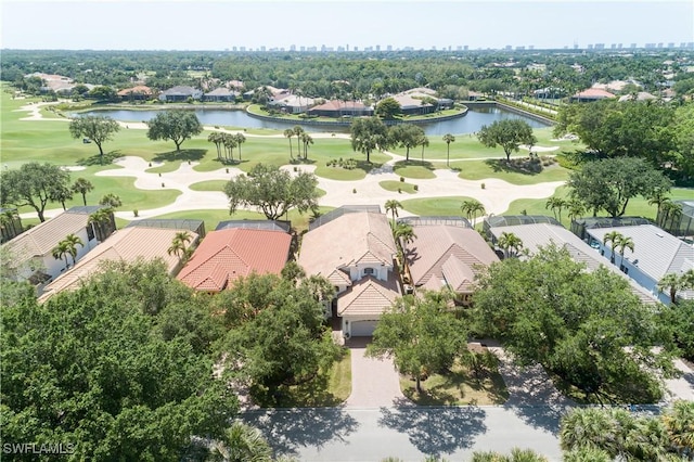 aerial view with golf course view, a water view, and a residential view
