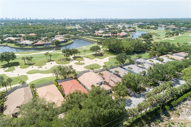 drone / aerial view featuring a view of city, golf course view, a residential view, and a water view