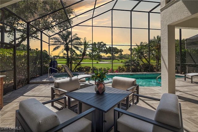 patio terrace at dusk featuring an outdoor pool and glass enclosure