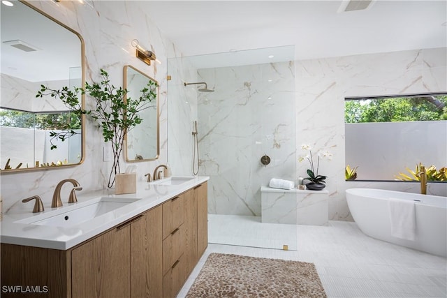204 Monterey Dr, Naples, FL 34119 - full bathroom featuring a marble finish shower, tile walls, a soaking tub, and double vanity