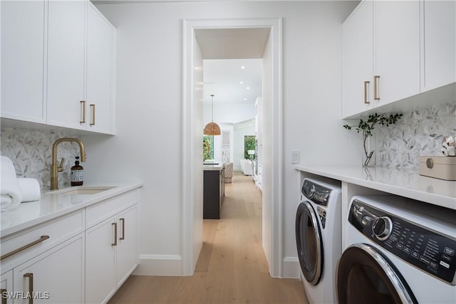 204 Monterey Dr, Naples, FL 34119 - laundry area featuring separate washer and dryer, cabinet space, light wood-type flooring, recessed lighting, and baseboards
