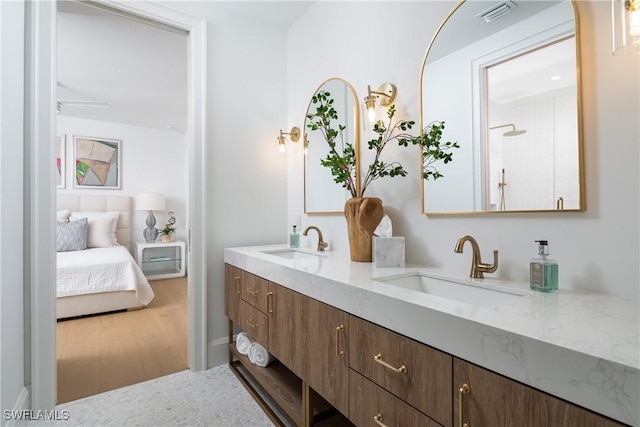 204 Monterey Dr, Naples, FL 34119 - full bath with double vanity, wood finished floors, and ensuite bath