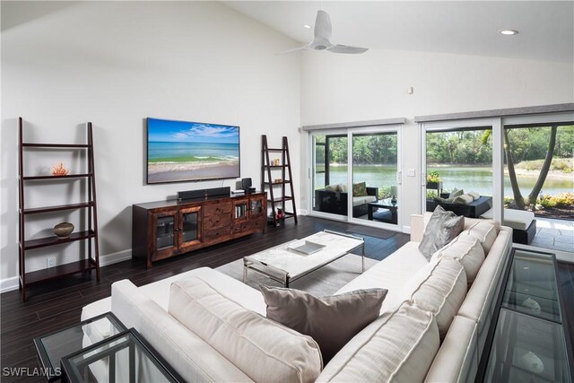 living area with recessed lighting, ceiling fan, baseboards, high vaulted ceiling, and dark wood-type flooring
