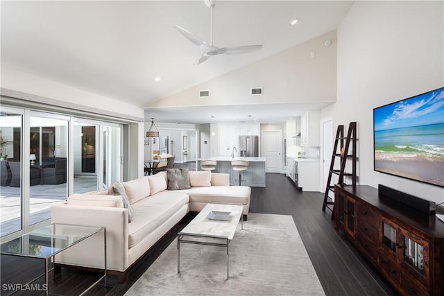 living room with recessed lighting, visible vents, a ceiling fan, dark wood-type flooring, and high vaulted ceiling