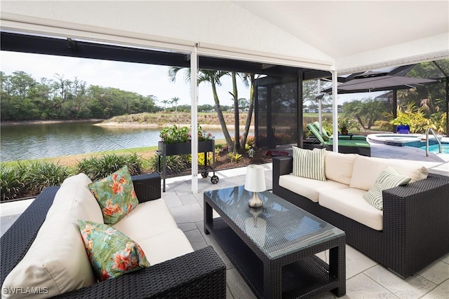sunroom / solarium featuring a water view, lofted ceiling, and a hot tub